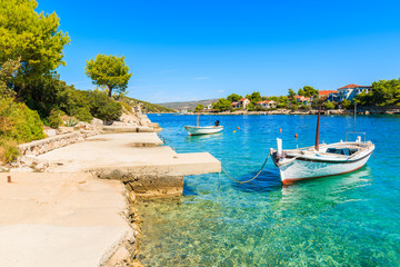 Fototapeta na wymiar Fishing boats anchoring in beautiful bay with turquoise sea water in Razanj port, Dalmatia, Croatia
