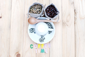 Bag of coffee beans and a cup of coffee on the table.