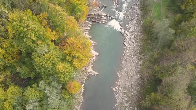 Top down aerial view of moving river Prut in Carpathian Mountains near by Yaremche, ukraine