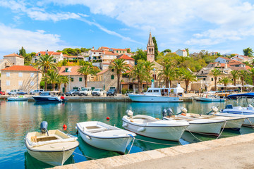 Fototapeta na wymiar Fishing boats in Splitska village with beautiful port, Brac island, Croatia