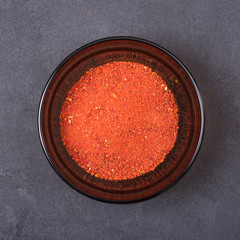 Sweet pepper in a bowl on a grey concrete background