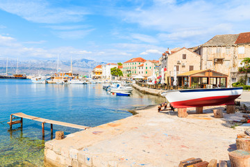 Fototapeta na wymiar Fishing boat in Postira village with beautiful port, Brac island, Croatia