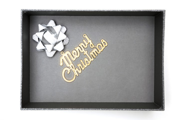 Merry christmas text and ribbon in black gift box
