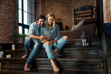 Couple at home watching tablet