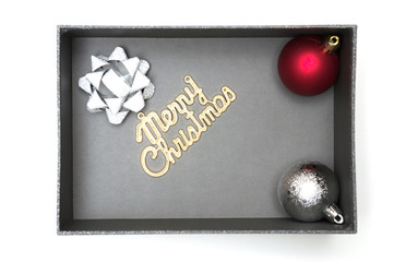 Fototapeta na wymiar Merry christmas text and ribbon, ball in black gift box
