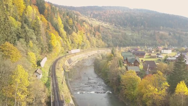 Flying over river Prut and train railways in Carpathian Mountains, Ukraine