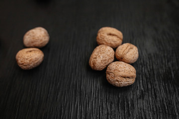 Lots of fresh nuts on a black wooden background. Best practices for designer