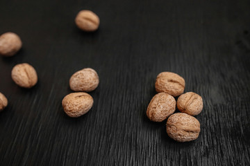 Lots of fresh nuts on a black wooden background. Best practices for designer