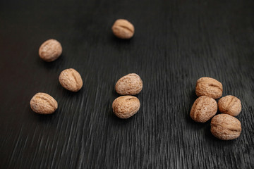 Lots of fresh nuts on a black wooden background. Best practices for designer