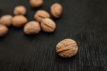 Lots of fresh nuts on a black wooden background. Best practices for designer