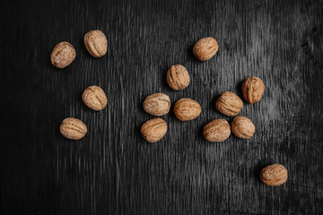 Lots of fresh nuts on a black wooden background. Best practices for designer