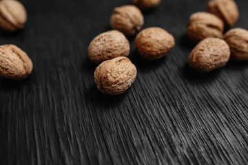 Lots of fresh nuts on a black wooden background. Best practices for designer