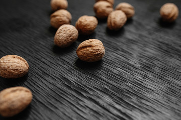 Lots of fresh nuts on a black wooden background. Best practices for designer
