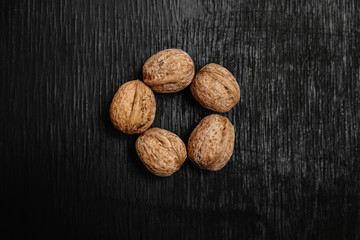 Lots of fresh nuts on a black wooden background. Best practices for designer. A beautiful design from the nuts
