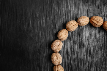 Lots of fresh nuts on a black wooden background. Best practices for designer. A beautiful design from the nuts