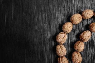 Lots of fresh nuts on a black wooden background. Best practices for designer. A beautiful design from the nuts