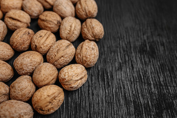 Lots of fresh nuts on a black wooden background. Best practices for designer. A beautiful design from the nuts