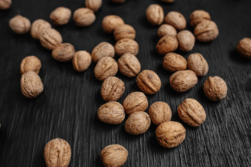 Lots of fresh nuts on a black wooden background. Best practices for designer