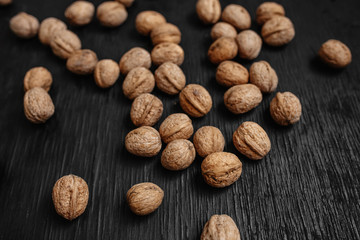 Lots of fresh nuts on a black wooden background. Best practices for designer