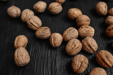 Lots of fresh nuts on a black wooden background. Best practices for designer