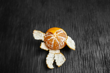 Tangerines on a black background. Lots of fresh fruit - mandarins.