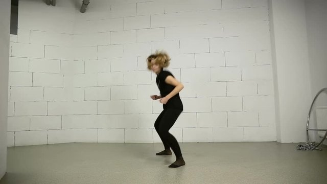 Asian woman dances in studio modern and street choreography Jazz-funk