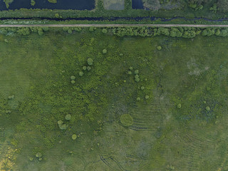 Aerial view over Raigardas valley surrounded by pine trees in Svendubre near the border, Lithuania. During summer season sundown.