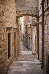 Narrow street with steps of medieval city Dubrovnik. Travel postcard vacation concept.