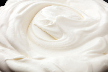 close up of a white whipped or sour cream in bowl