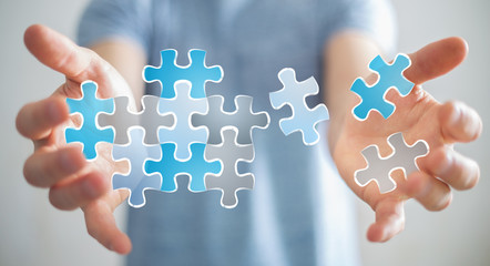 Businessman holding hand-drawn puzzle pieces