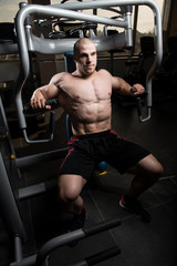 Fototapeta na wymiar Bodybuilder Exercising Chest On Machine