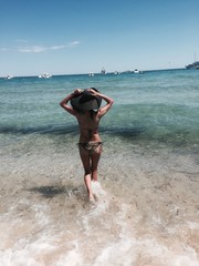 Women black bikini and hat in the sea
