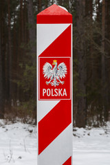 Border post with the emblem of the Polish. Border of Poland in winter.
