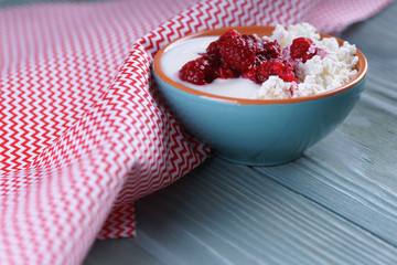 Homemade cottage cheese and yogurt with frozen raspberries