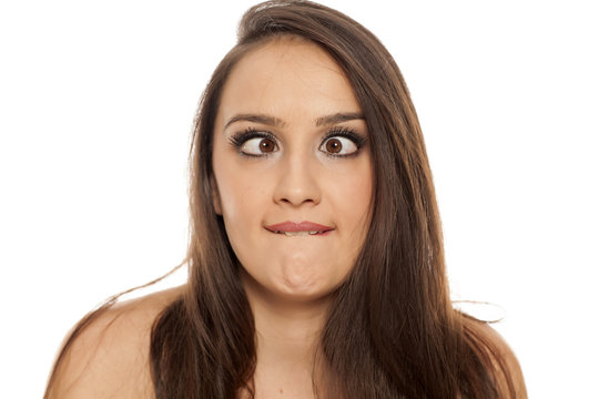 young silly woman make stupid faces on white background