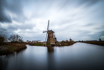 Naklejka premium Old windmills in Kinderdijk at sunrise, Holland, Netherlands, Europe. Unesco world heritage site.