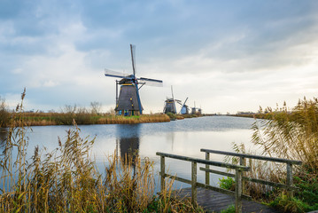 Old windmills in Kinderdijk at sunrise, Holland, Netherlands, Europe. Unesco world heritage site.