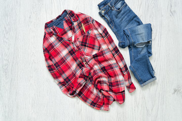 Checkered shirt and blue jeans. Fashionable concept