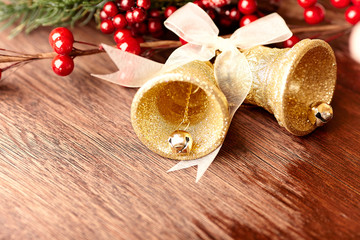 Rustic christmas bells on wooden background