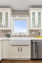 Modern kitchen interio with new stainless steel appliance and Farmhouse Sink.