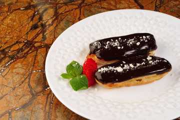 Eclair cakes on white plate background.Top view