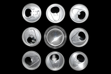 nine tin cans on a black background