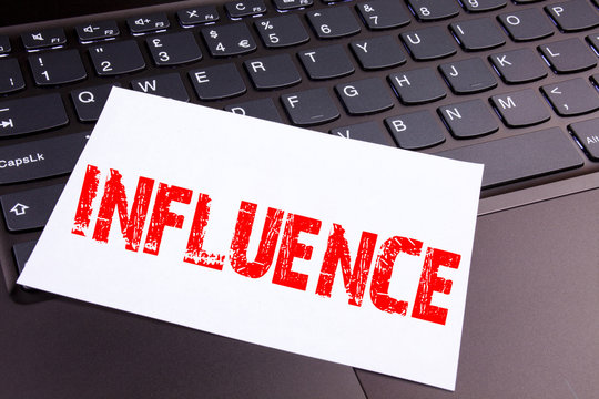 Writing Influence text made in the office close-up on laptop computer keyboard. Business concept for Business Analysis and Strategy Workshop on the black background with copy space