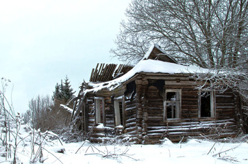 crumbling old log house in the village
