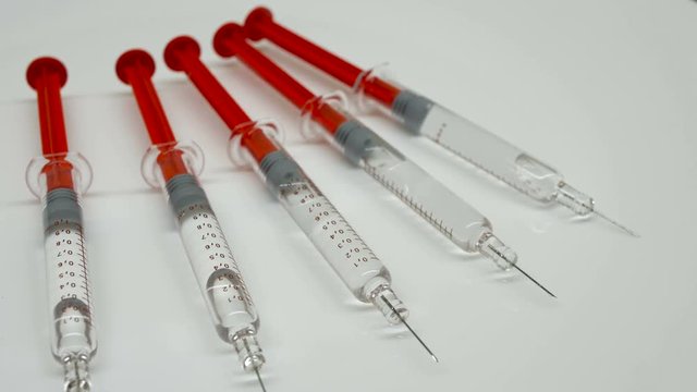 rotation of new unused syringes on white background