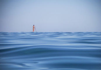Single Woman Stand-Up Paddleboarding Low Angle View