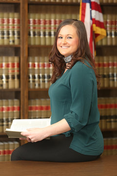 Portrait of a young attractive woman, woman lawyer in law library