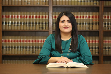 Young attractive hispanic woman, women attorney in law library, portrait of a woman lawyer