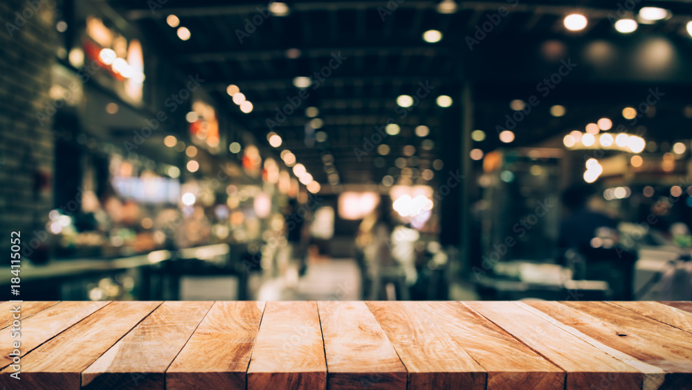 Sticker wood table top (bar) with blur light bokeh in dark night cafe,restaurant background