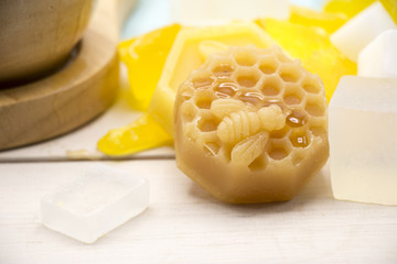 Honey soap on white wooden background